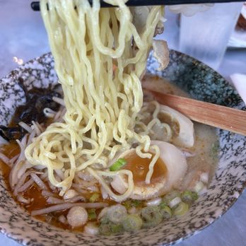 Tanaka Ramen - Tanaka Classic - A bowl of ramen featuring yellow noodles, a soft-boiled egg, green onions, and vegetables in a broth. - Ramen Near Me - Bolingbrook, Illinois
