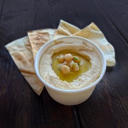 Barbonzai Lebanese Eatery - Our home-made creamy hummus, drizzled with olive oil. A very popular choice! Served with pita bread