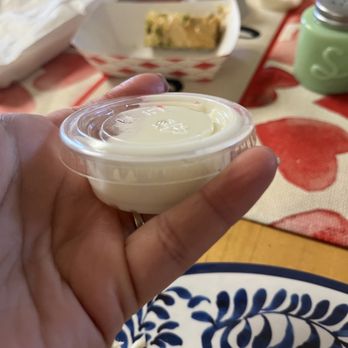 Kabab Crush - Image of the garlic sauce.  Order a few to take home. In the background is the pistachio baklava. A delicious (not too sweet) dessert. - Mediterranean Near Me - Corona, California