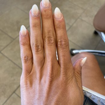 Epic Nail Spa - THIS IS THE AFTER!! truly the prettiest nails ever for my wedding day and In general - A hand displays neatly manicured, almond-shaped nails painted in a glossy white color, with a natural skin tone and visible skin texture. - Nail Salons Near Me - Franklin, Wisconsin