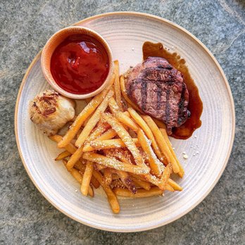 The Kini Room - Filet mignon with truffle fries and a freshly baked garlic bulb with olive oil. - Hawaiian Near Me - Honolulu, Hawaii The Kini Room - Filet mignon with truffle fries and a freshly baked garlic bulb with olive oil. - Hawaiian Near Me - Honolulu, Hawaii