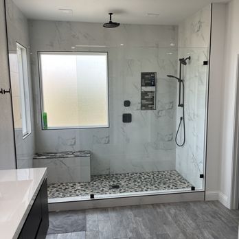 Ruben’s Crew Construction - a bathroom with a walk in shower - General Contractors Near Me