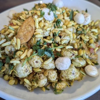 Delhi Darling - The quirky Makhana Bhel appetizer, a large bowl of popped lotus seeds, green mango, tomato with a tamarind chutney sauce. - Bars Near Me - Hampstead, North Carolina Delhi Darling - The quirky Makhana Bhel appetizer, a large bowl of popped lotus seeds, green mango, tomato with a tamarind chutney sauce. - Bars Near Me - Hampstead, North Carolina