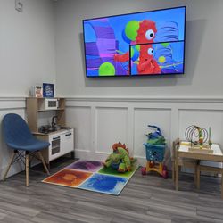 Farm Park Pediatric Dentistry - Waiting room play area with kid friendly shows.