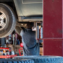 Billingsley Tire Service - Work in progress: Under the lift, mid-repair. Between lifts and tire racks, the shop clatters and buzzes with work. Serious workmanship.