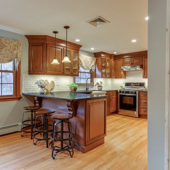 Kitchen Living - Updating this country kitchen we used Maple cabinetry with a Cinnamon glaze and Absolute Black Honed granite. - Kitchen & Bath Near Me - Marlborough, Connecticut