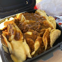 Chili cheese nachos. Typical big can cheese and chili nachos like at football games or the movies. Chili cheese nachos. Typical big can cheese and chili nachos like at football games or the movies.