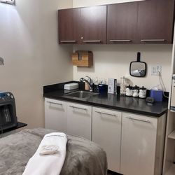 Hand & Stone Massage and Facial Spa - A pristine, advanced esthetics facial treatment room equipped with medical-grade DiamondGlow dermalinfusion and NuFace microc...