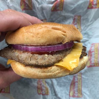 Fast Eddie's - a hand holding a sandwich - Fast Food Near Me - London, Ontario
