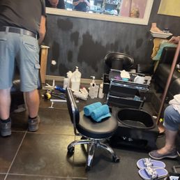A man is doing repairs during business hours while a women  is about to get a pedicure. This is far from a 5 star spa as falsely mentioned.