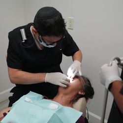 Atlantic Dental & Orthodontics - Dr. Tamir working on a dental patient.