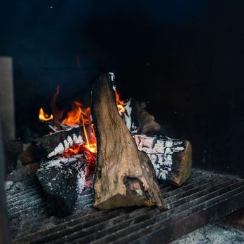 Black's BBQ - a fire in the grill - Barbeque Near Me - San Marcos, Texas