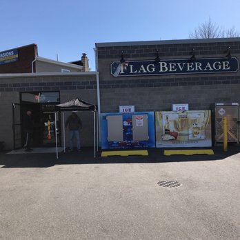 Flag Beverage - a man standing in front of a building - Beverage Store Near Me - Lindenhurst, New York Flag Beverage - a man standing in front of a building - Beverage Store Near Me - Lindenhurst, New York