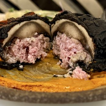 Botanico Waikiki - Inside view of Lava Funghi & Salsiccia. Charcoal-battered portobello mushrooms stuffed with Italian herb sausage over arrabiata sauce. - Mediterranean Near Me - Honolulu, Hawaii Botanico Waikiki - Inside view of Lava Funghi & Salsiccia. Charcoal-battered portobello mushrooms stuffed with Italian herb sausage over arrabiata sauce. - Mediterranean Near Me - Honolulu, Hawaii