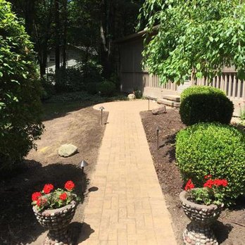 Second Nature Gardens - a brick walkway with potted plants - Landscaping Near Me - Saint Joseph, Michigan Second Nature Gardens - a brick walkway with potted plants - Landscaping Near Me - Saint Joseph, Michigan