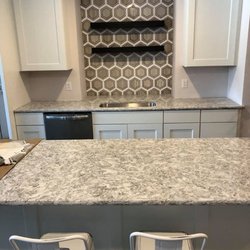 CraftMasters Flooring - Tile backsplash, dry cut installation, with black shelf inserts-balanced between tile design.