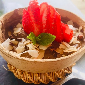 Pharm Table - Chocolate mousse with chocolate coconut and strawberries on top. Comes in a coconut shell. Nice - Cocktail Bars Near Me - San Antonio, Texas