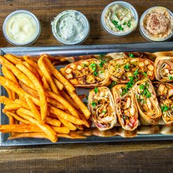 Shawarma Stop - Best Seller Item: Mix Box: Cut-to-Bite size Panini wrap - served with fries and your choice of two of Shawarma Stop sauces.