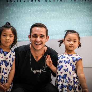 Pierce Aesthetics - Dr. Sean S Pierce taking a pic in front of the waterfall with our two new adorable patients - Endodontists Near Me - Tustin, California