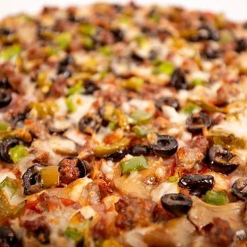 Johnny's Pizza House - a close up of a pizza - Pizza Near Me - Ruston, Louisiana