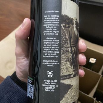 Vineyard Gate - a hand holding a bottle of wine - Beer, Wine & Spirits Near Me - Millbrae, California