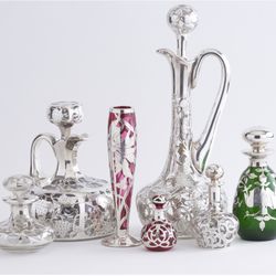Greenwald Antiques - A selection of Victorian, Art Nouveau, and Edwardian Sterling Silver Overlay Glass perfume bottles, ewers, decanters, and vases.
