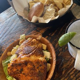 Mini Caesar with baked salmon and crispy chicken sandwich and kettle chips Mini Caesar with baked salmon and crispy chicken sandwich and kettle chips