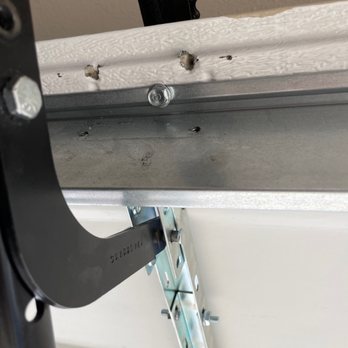 Rockwall Garage Door - Top is the original builder tension point ripped due to improper installation and the new frame supported install. - Garage Door Services Near Me Rockwall Garage Door - Top is the original builder tension point ripped due to improper installation and the new frame supported install. - Garage Door Services Near Me
