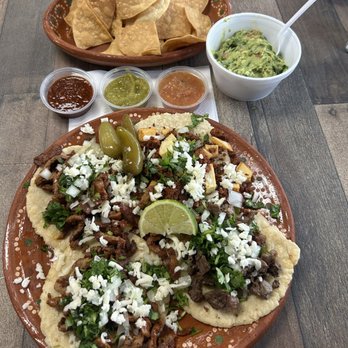 Alegro Taco Bar - Al pastor, soyrizo, carne asada + chips, guacamole, and salsa in the background - Tacos Near Me - Fullerton, California Alegro Taco Bar - Al pastor, soyrizo, carne asada + chips, guacamole, and salsa in the background - Tacos Near Me - Fullerton, California