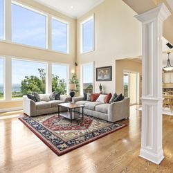 Aerial Photo Platform Productions - Living room with floor to ceiling windows.