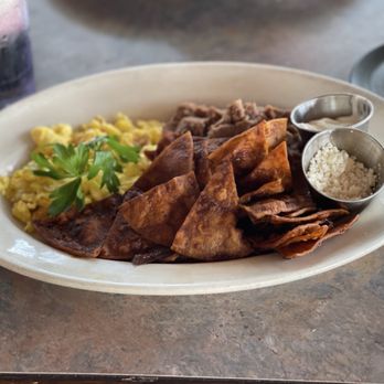 The Crooked Duck - Chilaquiles with eggs scrambled dry, feta and sour cream on the side - New American Near Me - Long Beach, California The Crooked Duck - Chilaquiles with eggs scrambled dry, feta and sour cream on the side - New American Near Me - Long Beach, California
