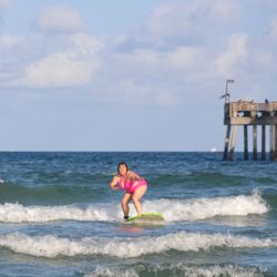 Vibe Surf School - Sharing the good vibes! Surfer catching one of the first waves of her life!