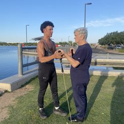 Fitness By Tracy - 81-year-old client in park work out.
