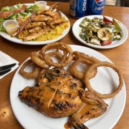 a plate of food with onion rings