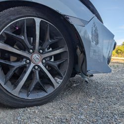 San Leandro Honda - Suspension suddenly dropped on this wheel, ripping off the fender liner and the bumper lip attached to it
