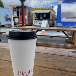 a cup of coffee on a picnic table a cup of coffee on a picnic table