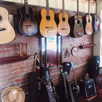 Hot Roast Company - a wall of guitars hanging on a brick wall - Sandwiches Near Me - Gananoque, Ontario Hot Roast Company - a wall of guitars hanging on a brick wall - Sandwiches Near Me - Gananoque, Ontario