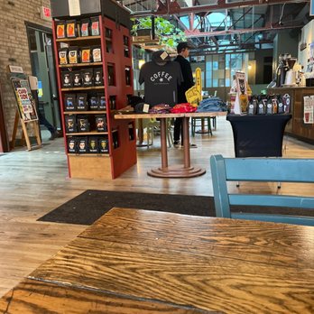 Colectivo Coffee Prospect Ave - a wooden table and chairs in a coffee shop - Coffee & Tea Near Me - Milwaukee, Wisconsin