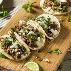 La Jefa Island Tacos - Carnitas tacos with onion and cilantro.