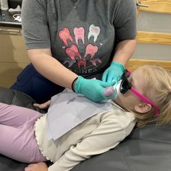Baines Dental Wellness - 3 year old sitting through her cleaning watching Bluey