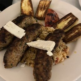 Persian kabobs with grilled vegetables. Feta cheese on top.