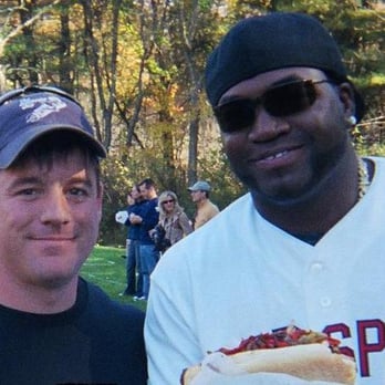 Johnny G's - Cookouts and Catering - a man holding a hot dog and a man wearing sunglasses - Hot Dogs Near Me Johnny G's - Cookouts and Catering - a man holding a hot dog and a man wearing sunglasses - Hot Dogs Near Me