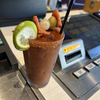 Tahoe Tavern & Grill - Bloody Mary with infused Tito's vodka with a bunch of vegetables topped by pepperoni, olive and onion. - American Near Me - Stateline, Nevada