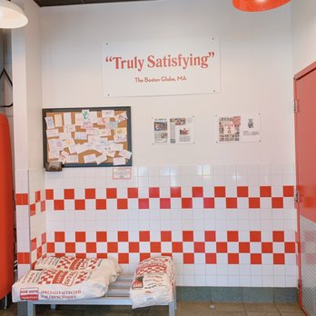Five Guys - a red and white checkered bench in a restaurant - Burgers Near Me - Enfield, Connecticut