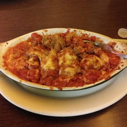 a dish of lasagna on a plate a dish of lasagna on a plate