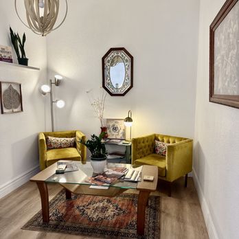 Fay Cafe - a living room with yellow chairs and a coffee table - Nurseries & Gardening Near Me - Sedona, Arizona