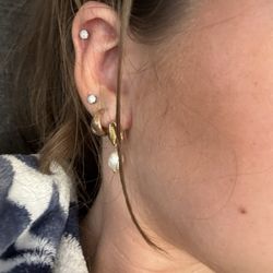 Blue Horseshoe Tattoo - Cartilage piercing and third lobe piercing a couple hours after they were done