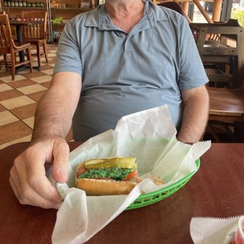 Culinary Delights - Culinary Delight Chicago hotdog enjoyment in process. - Sandwiches Near Me - Natick, Massachusetts