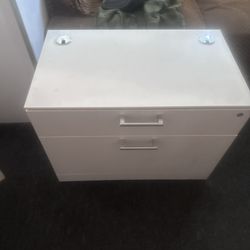 TR Trading Company - White  cabinet with a lock.