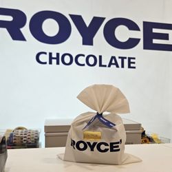 ROYCE' Chocolate - 8/14/2024 - My macadamia nuts covered in milk chocolate got super fancy when they were bagged up.